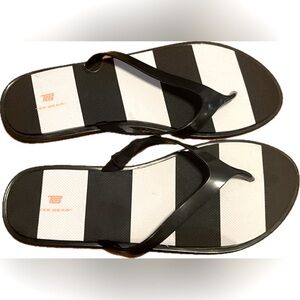 Tek Gear black and white flip flops. New with tag. Women’s size L (9-10)